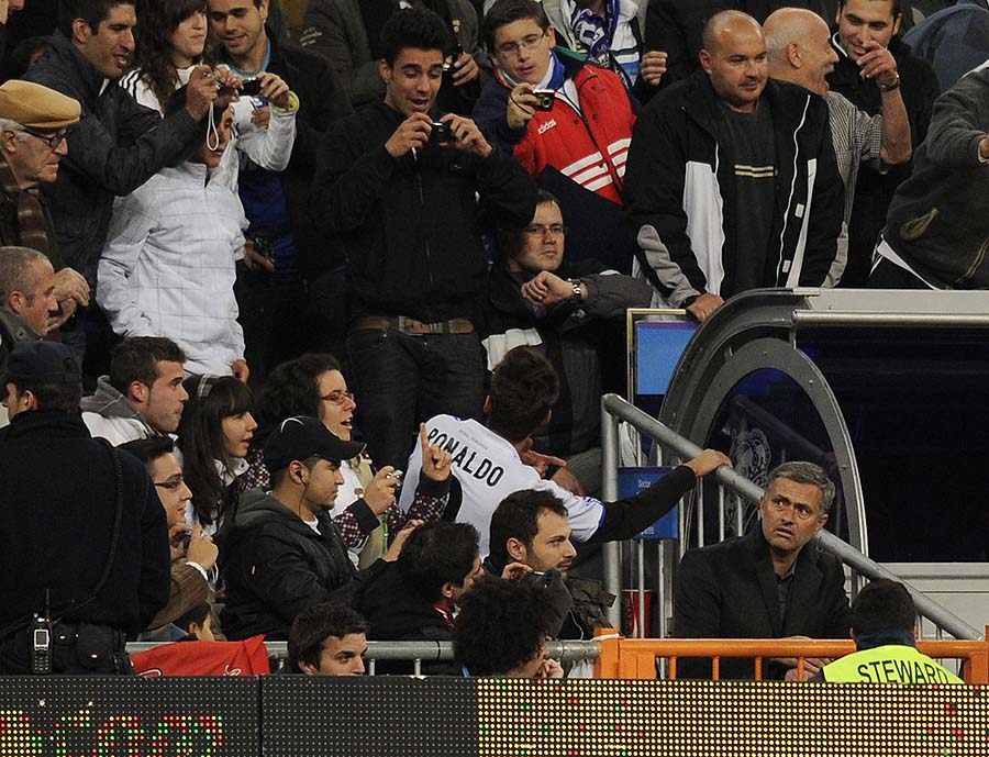 Football fans take pictures of Real Madrid's Portuguese coach Jose Mourinho (R) after he was sent of the pitch by referee during the Spanish King's Cup (Copa del Rey) football match Real Madrid against Murcia on November 10, 2010 at the Santiago Bernabeu stadium in Madrid.    AFP PHOTO/ JAVIER SORIANO