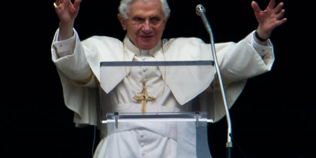 Pope Benedict XVI waves to faithfuls from the window of his apartment during his Sunday Angelus prayer in St. Peter's square at the Vatican on February 26, 2012.    AFP PHOTO / ANDREAS SOLARO