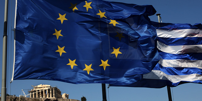 An EU and a Greek flag fly in front of ancient Parthenon temple, in Athens, Sunday, June 17, 2012 as Greeks vote in the most crucial elections in decades. Greece voted Sunday amid global fears that victory by parties that have vowed to cancel the country's international bailout agreements and accompanying austerity measures could undermine the European Union's joint currency and pitch the world's major economies into another sharp downturn. (AP Photo/Petros Giannakouris)