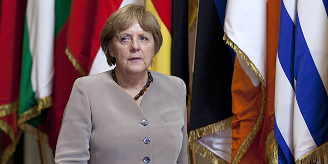 German Chancellor Angela Merkel leaves an EU Summit in Brussels on Friday, June 29, 2012. European leaders have agreed to use the continent's permanent bailout fund to recapitalize struggling banks, and agreed to the idea of a tighter union in the long term. (AP Photo/Virginia Mayo)