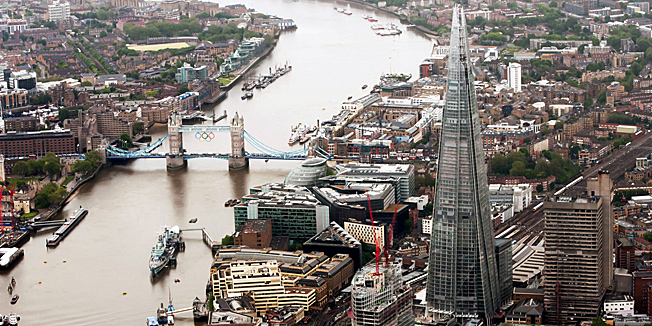This July 2, 2012 aerial photo made available by Newscast shows The Shard, a newly-constructed high-rise building in London, that is western Europes tallest, ahead of the official inauguration on Thursday, July 5, 2012. The Shard is 309.6 meters tall (1,016 feet) and features high quality offices, a 5-star hotel with more than 200 rooms and suites and 3 floors of restaurants. It will also feature exclusive super prime residential apartments and the top levels will consist of the capital's highest public viewing gallery offering 360° views of London.  (AP Photo/Newscast, Ben Fitzpatrick) EDITORIAL PURPOSES ONLY