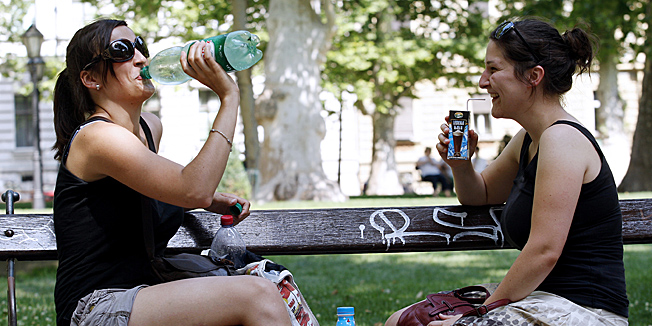 Zagreb, 050712.Zrinjevac.U Zagrebu se nastavlja val paklenih vrucina. Displej na Trgu bana Jelacica pokazivao je 35 stupnjeva Celzijevih, a gradjani se uglavnom drze hlada i fontana.Na slici: djevojke piju vodu.Foto: Tomislav Kristo / CROPIX