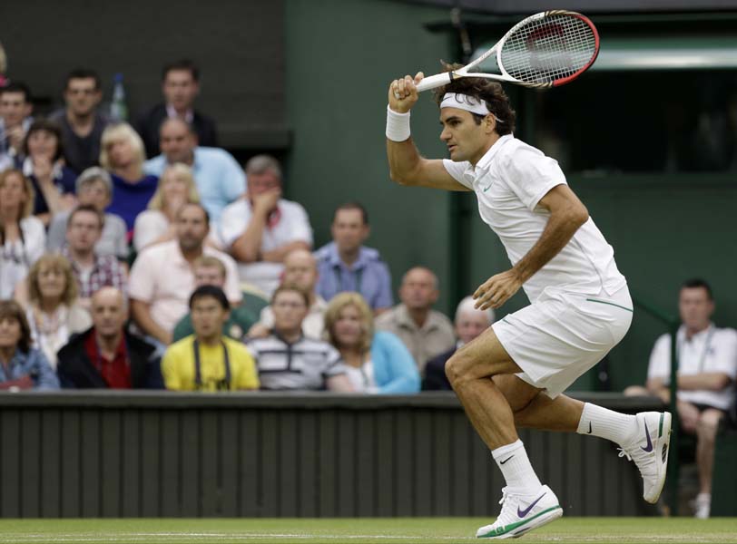 Roger Federer of Switzerland plays a shot to Novak Djokovic of Serbia during a semifinals match at the All England Lawn Tennis Championships at Wimbledon, England, Friday, July 6, 2012. (AP Photo/Anja Niedringhaus)