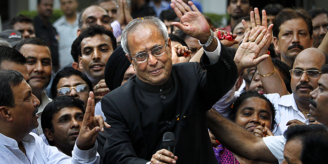 India's president elect Pranab Mukherjee greets media outside his residence after wining in New Delhi, India, Sunday, July 22, 2012. The candidate from Indias governing Congress party, former Finance Minister Mukherjee, was declared winner Sunday in the election for the countrys next president, a largely ceremonial position.  (AP Photo/ Manish Swarup)