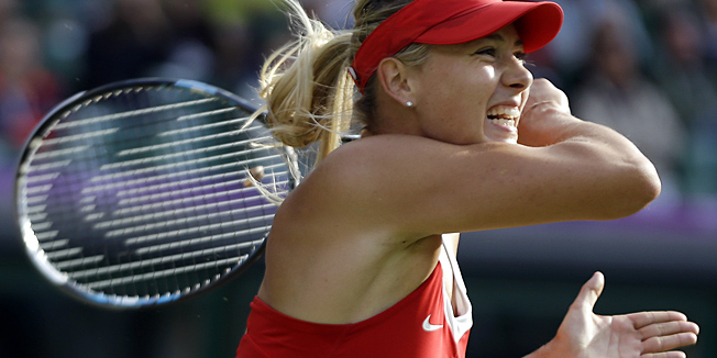Maria Sharapova of Russia returns to Kim Clijsters of Belgium at the All England Lawn Tennis Club in Wimbledon, London at the 2012 Summer Olympics, Thursday, Aug. 2, 2012. (AP Photo/Elise Amendola)