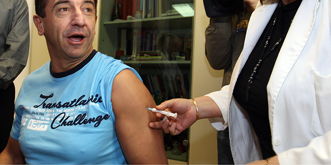 Gospic, 051209.Zupanijski dom zdravlja u Gospicu.Ministar  zdravstva Darko Milinovic sa svojom obitelji i suradnicima danas se cijepio protiv virusa H1N1.Na fotografiji: Doktorica Biserka Margaretic cijepi ministra Milinovica.Foto: Vladimir Ivanov / CROPIX