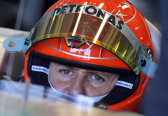 Mercedes' German driver Michael Schumacher sits in his car in the pits of Ricardo Tormo's racetrack during a training session in Cheste, near Valencia, on February 03, 2010. AFP PHOTO / PEDRO ARMESTRE 