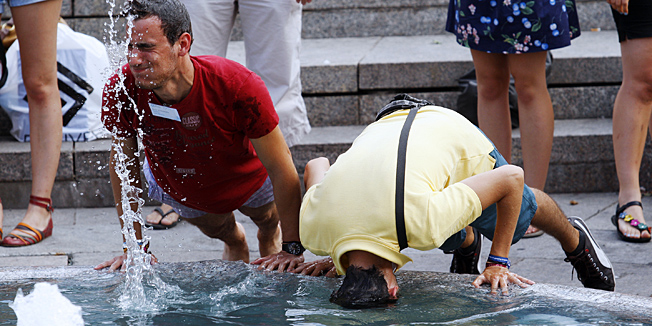 Zagreb, 060812.Trg bana Jelacica.U popodnevnim satima displej na Trgu bana Jelacica pokazivao je 35 stupnjeva Celzijusa. Zbog vrucine koja se isijavala iz asfalta turisti su se hladili u Mandusevcu, a najgore je radnicima koji moraju uredjivati ulice na nesnosnim temperaturama.Na slici: grupa turista hladi se u Manusevcu.Foto: Tomislav Kristo / CROPIX