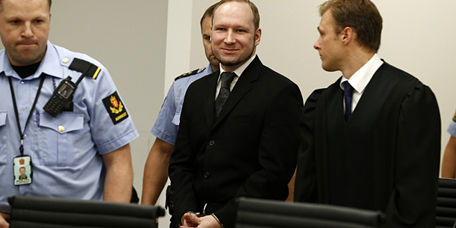 Mass murderer Anders Behring Breivik, centre, arrives at the court room in a courthouse in Oslo  Friday Aug. 24, 2012 . Breivik will receive his judgment for Norway's worst peacetime attacks, a bomb and gun rampage that left 77 people dead in July last year. (AP Photo/Heiko Junge / NTB scanpix, Pool)