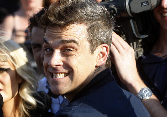 British pop star Robbie Williams pulls a funny face as he arrives at the 2009 ARIA Awards in Sydney, Australia, Thursday, Nov. 26, 2009. (AP Photo/Rob Griffith)