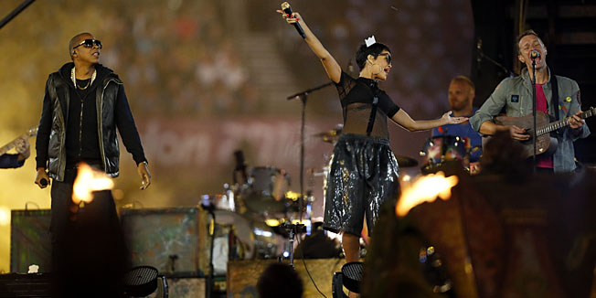 U.S. rapper Jay-Z, left, singer Rihanna, center, from Barbados and British musician Chris Martin, right, the frontman of the band Coldplay perform during the closing ceremony for the 2012 Paralympics, Sunday, Sept. 9, 2012, in London.  (AP Photo/Matt Dunham)