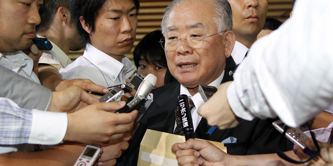 FILE - In this June 4, 2012 file photo, newly-appointed Financial and Postal Reform Minister Tadahiro Matsushita speaks as he is surrounded by reporters after Japanese Prime Minister Yoshihiko Noda reshuffled his Cabinet at the prime minister's official residence in Tokyo. Police said in a statement that Matsushita was found dead at his home in Tokyo on Monday, Sept. 10, 2012. He was 73. Police are investigating the cause of death. (AP Photo/Koji Sasahara, File)
