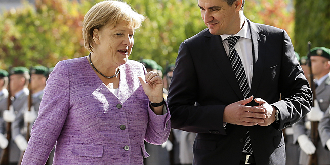 German Chancellor Angela Merkel, left, welcomes the Prime Minister of Croatia Zoran Milanovic at the chancellery in Berlin, Wednesday, Sept. 19, 2012. Milanovic is on a one-day visit to Germany.  (AP Photo/Markus Schreiber)