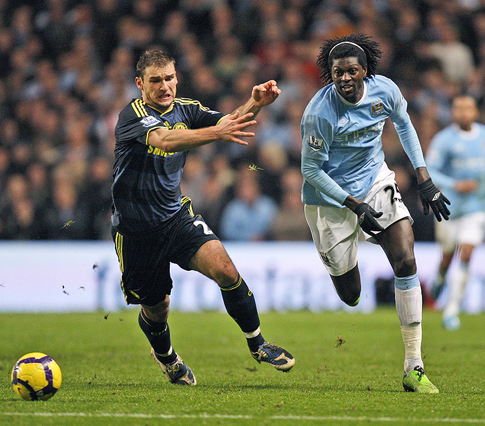 Manchester City's Emmanuel Adebayor, right, fights for the ball against Chelsea's Branislav Ivanovic during their English Premier League soccer match at The City of Manchester Stadium, Manchester, England, Saturday Dec. 5, 2009. (AP Photo/Jon Super) ** NO INTERNET/MOBILE USAGE WITHOUT FOOTBALL ASSOCIATION PREMIER LEAGUE (FAPL) LICENCE. CALL +44 (0) 20 7864 9121 or EMAIL info@football-dataco.com FOR DETAILS **