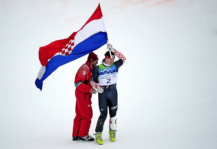 Croatia's silver medalist Ivica Kostelic and his father Ante Kostelic celebrates with their national flag after the flower ceremony of the men's slalom race of the Vancouver 2010 Winter Olympics at the Whistler Creek side Alpine skiing venue on February 27, 2010. AFP PHOTO OLIVIER MORIN