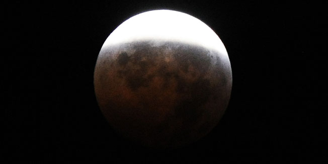 The moon is pictured during its circle of a total eclipse as seen from Silver Spring, Maryland, on December 21, 2010. This eclipse takes place just hours before the December solstice, which marks the beginning of northern winter and southern summer. AFP PHOTO/Jewel Samad