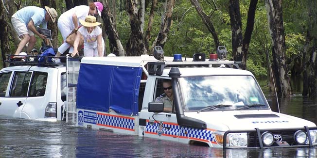 In this photo released by the Northern Territory Police, four German tourists are safely rescued from the flooded Magela Creek, near Jabiru, Australia, Monday, Jan. 3, 2011. Drenching rain that started before Christmas has flooded an area the size of France and Germany combined. (AP Photo/Northern Territory Police) EDITORIAL USE ONLY