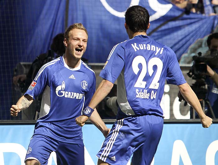 RESTRICTIONS / EMBARGO - ONLINE CLIENTS MAY USE UP TO SIX IMAGES DURING EACH MATCH WITHOUT THE AUTHORISATION OF THE DFL. NO MOBILE USE DURING THE MATCH AND FOR A FURTHER TWO HOURS AFTERWARDS IS PERMITTED WITHOUT THE AUTHORISATION OF THE DFL.Schalke's Croatian midfielder Ivan Rakitic (L) celebrates scoring with Schalke's striker Kevin Kuranyi during the German first division Bundesliga football match FC Schalke vs Borussia Moenchengladbach in the western German city of Gelsenkirchen on April 17, 2010. AFP PHOTO DDP /  JUERGEN SCHWARZ GERMANY OUT