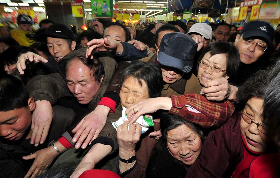 In a picture taken on March 17, 2011 Chinese shoppers crowd a shop in an effort to buy salt in Lanzhou, northwest China's Gansu province. Chinese retailers on March 17 reported panic buying of salt, partly because shoppers believe it could help ward off the effects of potential radioactivity from Japan's crippled nuclear power plant. Chinese consumers are hoping iodine in the iodised salt can reduce the impact of possible radioactivity as the crisis at Japan's Fukushima nuclear plant deepens. But state-run China National Radio said the iodine content of edible salt in the country averages between 20-30 microgrammes per kilogramme, quoting experts saying that is too low to have any effect.  CHINA OUT AFP PHOTO