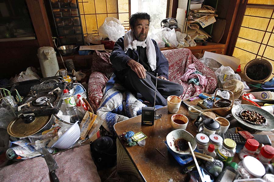 Kunio Shiga listens to a battery-powered radio in the living room of his home in Minami Soma, Fukushima Prefecture, inside the deserted evacuation zone established for the 20 kilometer radius around the Fukushima Dai-ichi nuclear complex in northeastern Japan Friday, April 8, 2011. The 75-year-old man was stranded alone in his farmhouse ever since Japan's monstrous tsunami struck nearly a month ago. (AP Photo/Hiro Komae)
