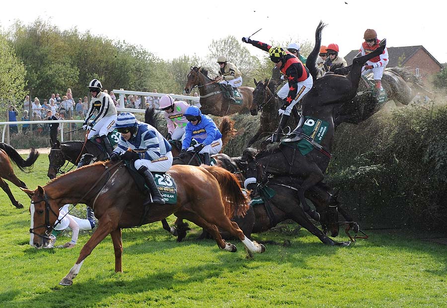Several horses fall at Bechers Brook in the Grand National during Grand National Day at Aintree Racecourse, Liverpool Saturday April 9, 2011.   (AP Photo/John Giles/PA Wire)  UNITED KINGDOM OUT NO SALES NO ARCHIVE