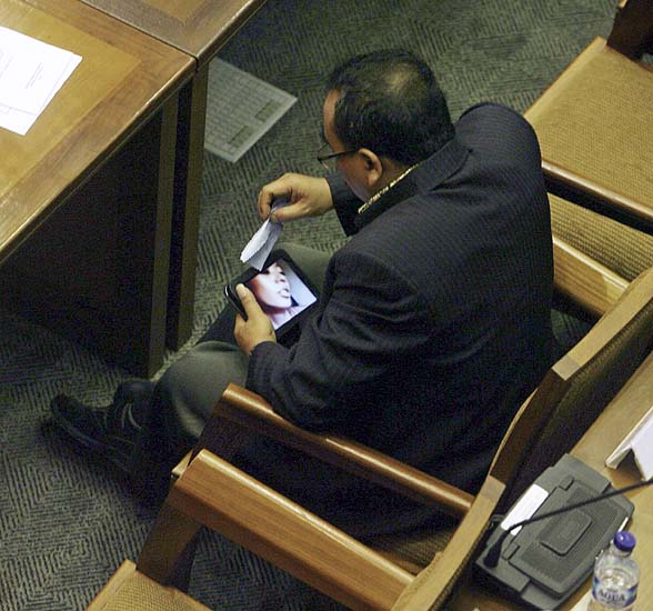 In this photo taken on Friday, April 8, 2011, Indonesian parliament member from Prosperous Justice Party (PKS) Arifinto watches a porn video on his tablet computer. The conservative lawmaker who helped pass a controversial anti-pornography law resigned Monday, April 11, 2011 after he was caught watching explicit videos on his computer during a parliamentary session. (AP Photo/Media Indonesia, M. Irfan) MANDATORY CREDIT, NO ARCHIVE, NO SALES