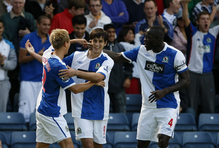 Blackburn's Nikola Kalinic, center, is congratulated by team mates Morten Gamst Pedersen, left, and Chris Samba after scoring a goal against Everton during their English Premier League soccer match at Ewood Park, Blackburn, England, Saturday, Aug. 14, 2010. (AP Photo/Tim Hales) ** NO INTERNET/MOBILE USAGE WITHOUT FOOTBALL ASSOCIATION PREMIER LEAGUE (FAPL) LICENCE. CALL +44 (0) 20 7864 9121 or EMAIL info@football-dataco.com FOR DETAILS **
