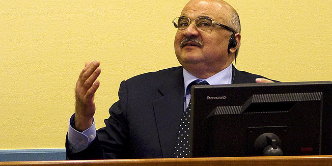 Former Croatian General Ante Gotovina, back row left, listens at Ivan Cermak, back row right, in the courtroom of the Yugoslav war crimes tribunal in The Hague, Netherlands, Friday, April 15, 2011. A U.N. court is to issue verdicts Friday in the war crimes case of three Croat generals, Ante Gotovina, Ivan Cermak and Mladen Markac, charged in the murder, mistreatment and deportation of Serbs in a 1995 military blitz known as Operation Storm. (AP Photo/Jerry Lampen, Pool)
