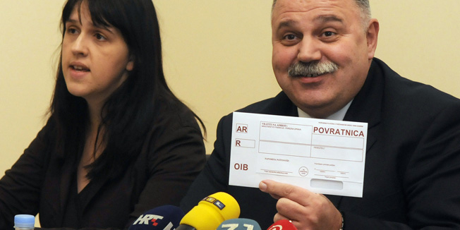 Zagreb, 161208.Ministarstvo financija, prezentacija o uvodjenju Osobnog identifikacijskog broja (OIB) kojeg ce pocetkom 2009. godine automatski dobivati svako novorodjeno dijete i svaka novoosnovano poduzece. Gradjani ce obavijesti poceti dobivati od 2. sijecnja 2009. Ministar financija Ivan Suker pokazuje kovertu s povratnicom kakve ce se slati gradjanima u kojoj ce se nalaziti obrazac s OIB.Foto: Bruno Konjevic / CROPIX