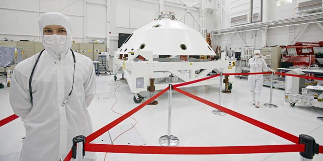 NASA engineers stand by Mars Science Laboratory's aeroshell, a conical shell that will help protect the rover 