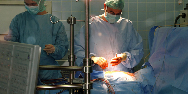 FILE - In this  June 4, 2006 file photo  physicians of the University hospital in Heidelberg, southwestern Germany working during an emergency surgery. Legislation passed Wednesday, March 23, 2011 by Chancellor Angela Merkel's Cabinet aims to make it easier for foreign professionals to use their skills in Germany and to speed up the recognition of their foreign qualifications. Physicians are also desperately needed. The doctor's association Marburger Bund says there's a lack of 12,000 physicians at hospitals and 3,000 general practitioners across the countries. (AP Photo/Daniel Roland,File)