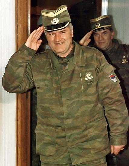 230206Bosnian Serb army Commander General Ratko Mladic (L) salutes followed by his senior aide General Milan Gvero (R) in Belgrade in this March 26,1993 file photo.  A close aide to top Bosnian Serb fugitive Ratko Mladic, general Gvero (67) who surrendered on Monday, faces war crimes charges of murder, prosecution and deportation of Bosnian Muslims during war conflict in former Yugoslavia. Gvero is being taken to Belgrade's airport for departure to The Hague U.N. Tribunal today. PICTURE TAKEN 26 MARCH 1993  REUTERS/Petar Kujundzic/Files-desk-mag