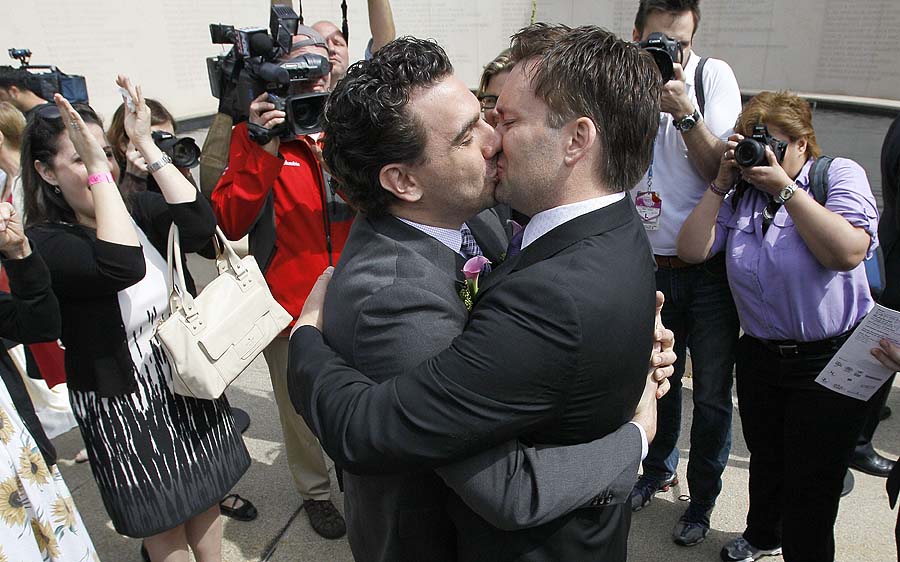 Frank Baiocchi, left, and Robert Hunt kiss after their civil union ceremony in Chicago's Millennium Park Thursday, June 2, 2011 in Chicago. Nearly three-dozen gay couples held a mass civil unions ceremony a day after Illinois became the seventh state in the country to legalize the unions. (AP Photo/Charles Rex Arbogast)
