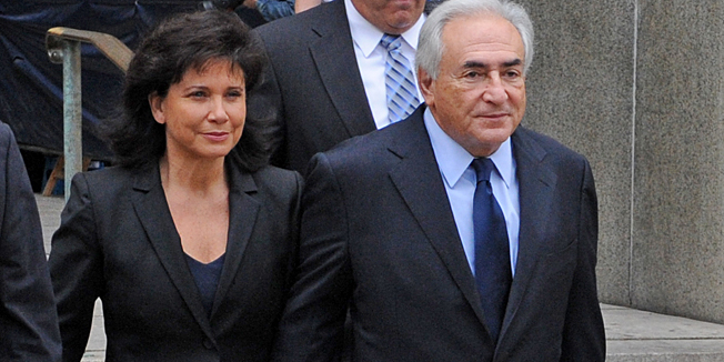 Former International Monetary Fund leader Dominique Strauss-Kahn, right, exits Manhattan Criminal Court with his wife Anne Sinclair, after his arraignment on charges of sexually assaulting a Manhattan hotel maid Monday, June 6, 2011, in New York. Strauss-Kahn pleaded not guilty. (AP Photo/ Louis Lanzano)    