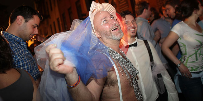 NEW YORK, NY - JUNE 24: Revelers celebrate in front of the historic gay bar The Stonewall after the passing of a bill legalizing gay marriage in New York State on June 24, 2011 in New York City. New York State now joins Connecticut, Massachusetts, New Hampshire, Vermont, Iowa and Washington, D.C. in legally recognizing gay marriage.   Spencer Platt/Getty Images/AFP== FOR NEWSPAPERS, INTERNET, TELCOS & TELEVISION USE ONLY ==