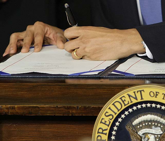 FILE - In this March 23, 2010, file photo President Barack Obama signs the health care bill in the East Room of the White House in Washington. Presidents of both parties have been using autopens decades. But in May, 2011, Obama while overseas directed his Washington staff to use it to sign a bill into law, apparently a first. Stephen Koschal, an autograph authenticator who two years ago published a guide to presidential autopen signatures said 