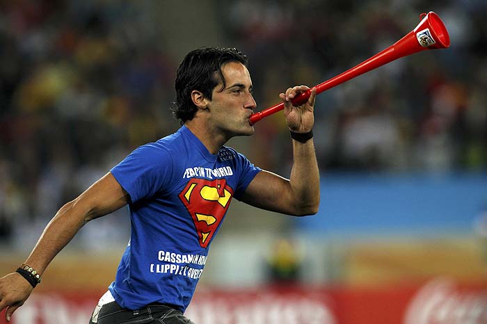 A man blows a vuvuzela on the field and interrupts game play in the 2010 World Cup semi-final soccer match between Germany and Spain at Moses Mabhida stadium in Durban July 7, 2010.     REUTERS/Ina Fassbender (SOUTH AFRICA  - Tags: SPORT SOCCER WORLD CUP)