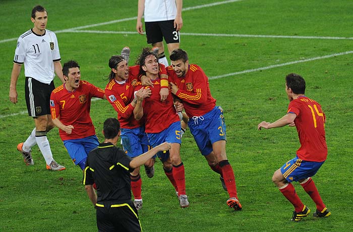 Spain's players celebrate after defender Carles Puyol (C) scored during the 2010 World Cup semi-final football match Germany vs. Spain on July 7, 2010 at Moses Mabidha Stadium in Durban. NO PUSH TO MOBILE / MOBILE USE SOLELY WITHIN EDITORIAL ARTICLE -  AFP PHOTO / PEDRO UGARTE