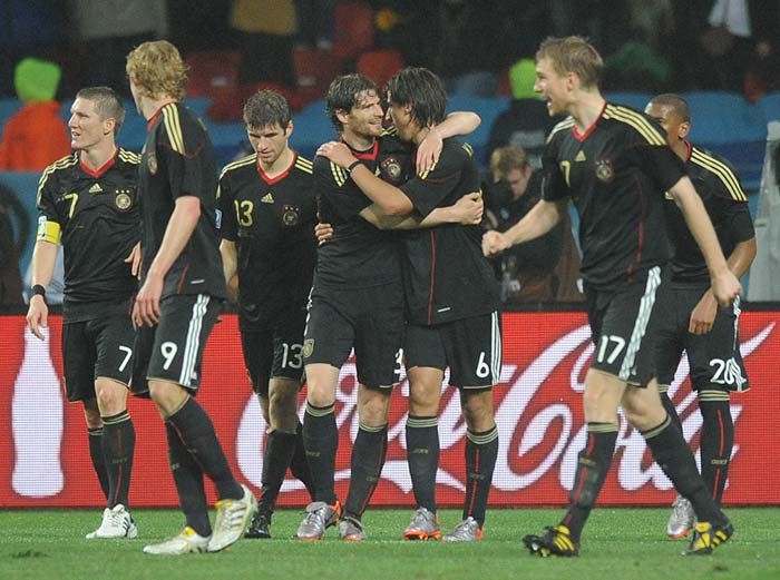 Germany's midfielder Sami Khedira (6) celebrates with Germany's defender Arne Friedrich (3), Germany's defender Per Mertesacker (17) and Germany's midfielder Thomas Mueller after scoring his team's third goal during the 2010 World Cup third place match Uruguay vs Germany on July 10, 2010 at the Nelson Mandela Bay stadium in Port Elizabeth. NO PUSH TO MOBILE / MOBILE USE SOLELY WITHIN EDITORIAL ARTICLE           AFP PHOTO / RODRIGO ARANGUA