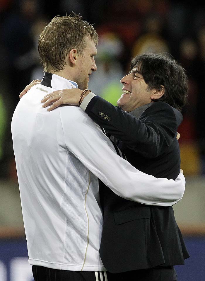 Germany head coach Joachim Loew, right, congratulates Per Mertesacker  after the World Cup third-place soccer match between Germany and Uruguay at Nelson Mandela Bay Stadium in Port Elizabeth, South Africa, Saturday, July 10, 2010.  Germany won 3-2. (AP Photo/Gero Breloer)