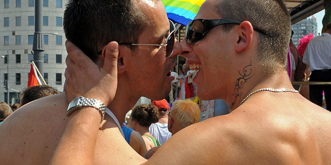 Participants kiss as they march during the Euro Pride gay parade in Warsaw on July 17, 2010. Thousands of gays, lesbians, bisexuals and supporters of equal rights for sexual minorities marched in Warsaw urging Poland's government to give homosexual partnerships legal status. AFP PHOTO / JANEK SKARZYNSKI