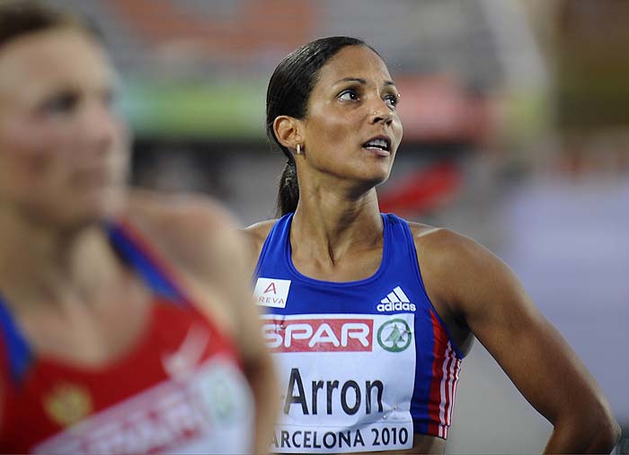 France's Christine Arron watches the scoreboard after finishing third during the women's 100m semi-final heat 2 at the 2010 European Athletics Championships at the Olympic Stadium in Barcelona on July 29, 2010. AFP PHOTO / PIERRE-PHILIPPE MARCOU