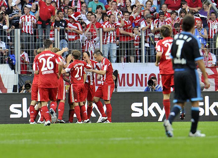 Munich's players celebrate after scoring during the Supercup Final soccer match between FC Schalke 04 and FC Bayern Munich in Augsburg, southern Germany, on Saturday, Aug. 7, 2010.  (AP Photo/Kerstin Joensson)