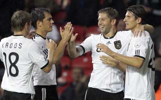 Germany's Mario Gomez, right, celebrates with teammates after scoring during the international friendly soccer match between Denmark and Germany in Copenhagen, Denmark, Wednesday Aug.11,2010. (AP Photo/Frank Augstein)