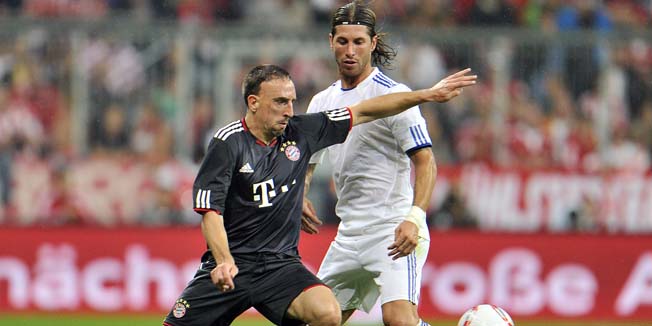 Munich's Franck Ribery, left, and Madrid's Sergio Ramos, right, challenge for the ball during  their international friendly soccer match  between FC Bayern Munich and  Real Madrid in Munich, southern Germany, Friday, Aug. 13, 2010. Fully 33 years later the farewell match will honor Franz Beckenbauer, who never received the honor when he left Munich to join the New York Cosmos, and later Hamburger SV. (AP Photo/Kerstin Joensson)