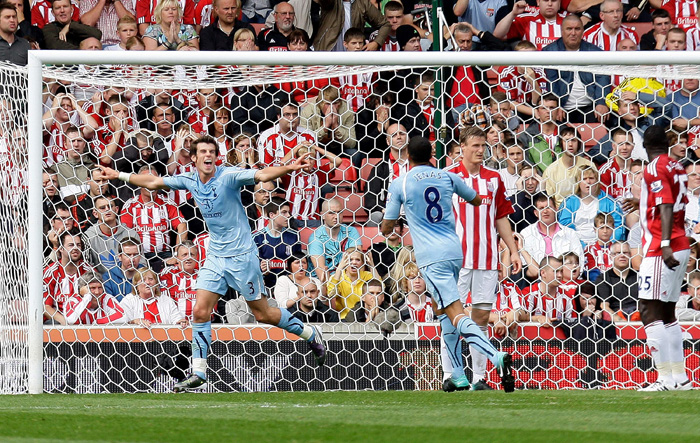 Tottenham Hotspurs Gareth Bale, left, celebrates scoring his teams first goal during their English Premier League soccer match against Stoke City at the Britannia stadium, Stoke, England. Saturday, Aug. 21, 2010. (AP Photo/Simon Dawson)**NO INTERNET/MOBILE USAGE WITHOUT FOOTBALL ASSOCIATION PREMIER LEAGUE (FAPL) LICENCE. CALL +44 (0) 20 7864 9121 or EMAIL info@football-datco.com FOR DETAILS **