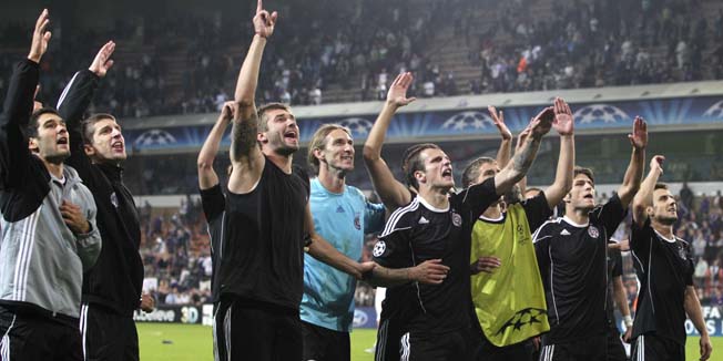 Serbia's FK Partizan Belgrade players cheer, after they beat Belgium's RSC Anderlecht during the play-off's, second leg, of the Champions League in Brussels, Belgium, Tuesday Aug. 24, 2010. (AP Photo/Yves Logghe)