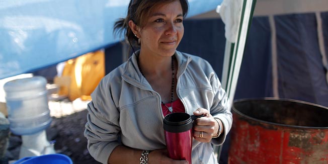 Carola Narvaez, wife of Raul Bustos, one of 33 miners trapped in the collapsed San Jose mine, stands in a shelter for relatives outside the mine in Copiapo, Chile, Thursday Aug. 26, 2010.  Narvaez and her husband survived Chile's massive February earthquake. (AP Photo/Natacha Pisarenko)