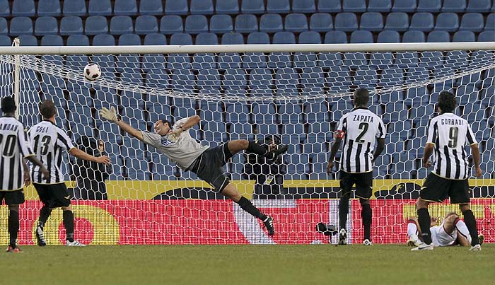 Genoa's Giandomenico Mesto, right, lying on the pitch, scores the decisive goal that gave his side a 1-0 win over Udinese, during a Serie A soccer match in Udine, Italy, Saturday, Aug. 28, 2010. (AP Photo/Franco Debernardi)