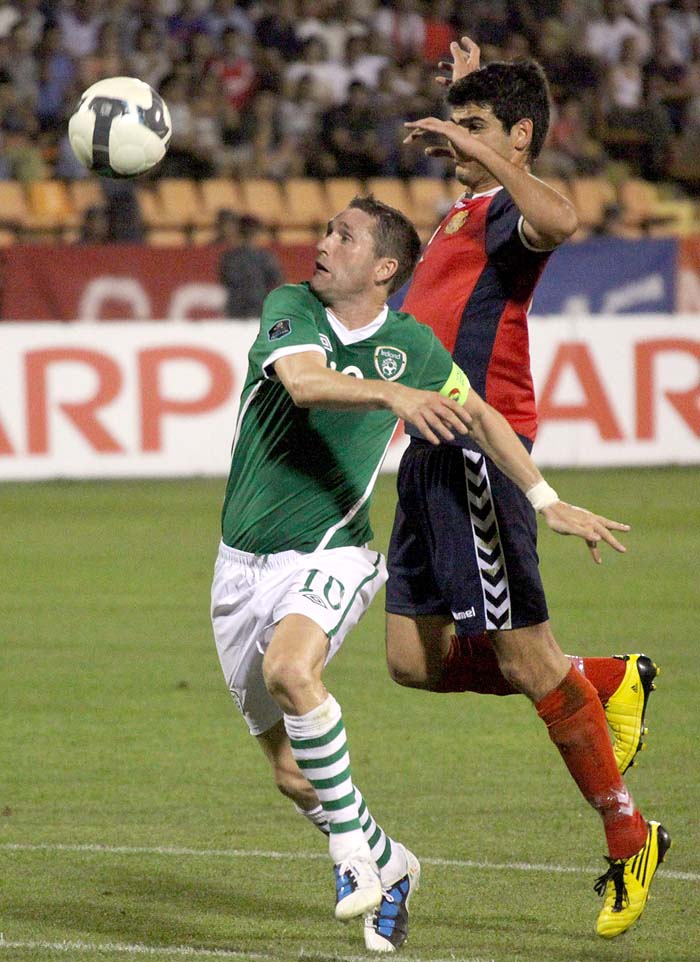 Ireland's Robbie  Keane, left, and Armenia's Robert Arzumanyan fight for the ball during their Euro 2012 Group B qualifying soccer match in Yerevan, Armenia, Friday Sept. 3, 2010. (AP Photo/Vahram Baghdasaryan, Photolure)